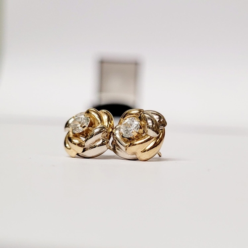 128 - A PAIR OF 9CT DUAL TONED GOLD STUD EARRINGS, with a central solitaire clear gemstone setting, marked... 