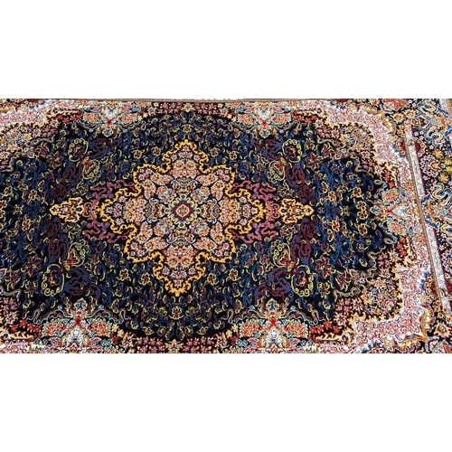 180 - A PERSIAN BARZIN FLOOR RUG dark blue, in style of classical Persian silk rug; striking central flora... 