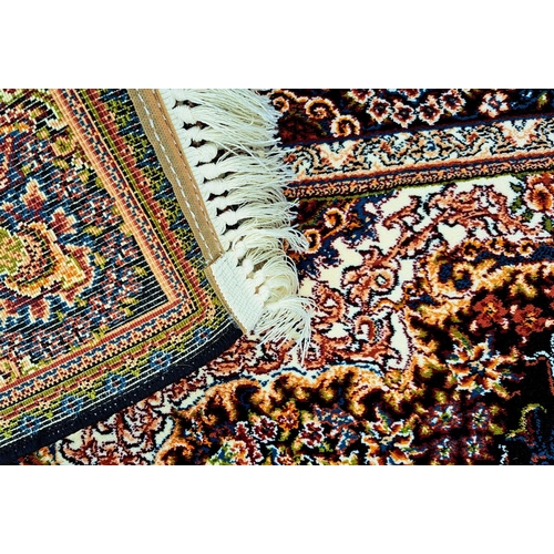 180 - A PERSIAN BARZIN FLOOR RUG dark blue, in style of classical Persian silk rug; striking central flora... 