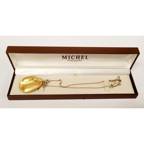 223 - A CASED ALEXIS BITTAR LUCITE & GOLD PENANT NECKLACE, the oval shaped pendant is a bright golden colo... 