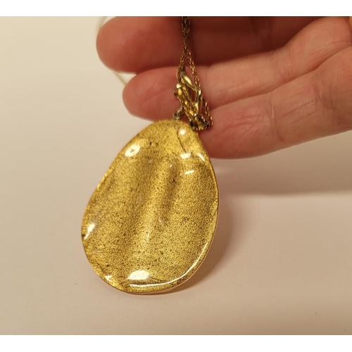223 - A CASED ALEXIS BITTAR LUCITE & GOLD PENANT NECKLACE, the oval shaped pendant is a bright golden colo... 