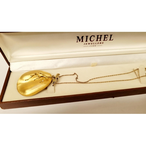 223 - A CASED ALEXIS BITTAR LUCITE & GOLD PENANT NECKLACE, the oval shaped pendant is a bright golden colo... 