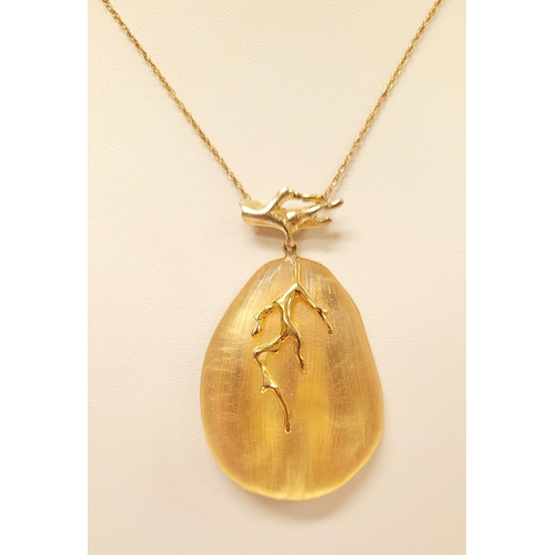 223 - A CASED ALEXIS BITTAR LUCITE & GOLD PENANT NECKLACE, the oval shaped pendant is a bright golden colo... 