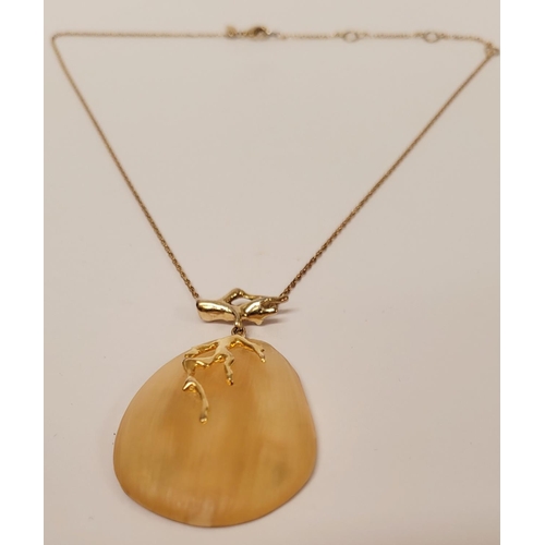 223 - A CASED ALEXIS BITTAR LUCITE & GOLD PENANT NECKLACE, the oval shaped pendant is a bright golden colo... 