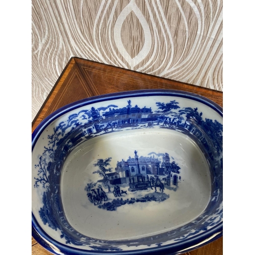 281 - A BLUE & WHITE COLOURED FOOT BATH PLANTER, decorated to both the exterior and interior with building... 