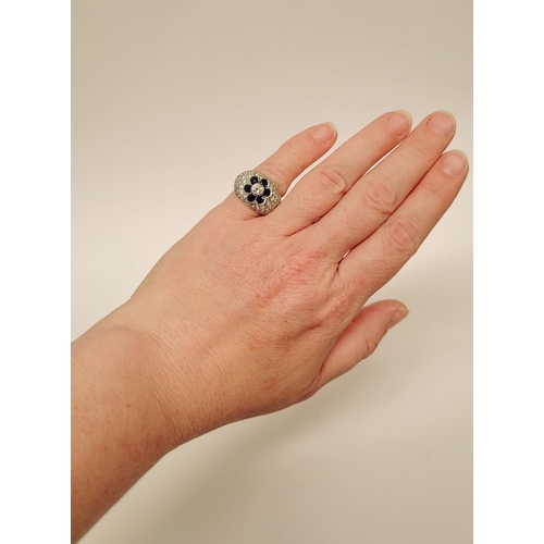 82 - A PRETTY 18CT WHITE GOLD SAPPHIRE & DIAMOND FLORAL CLUSTER / DRESS BOMBE SHAPED RING, the curved set... 