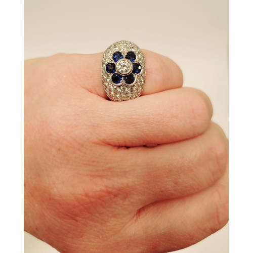 82 - A PRETTY 18CT WHITE GOLD SAPPHIRE & DIAMOND FLORAL CLUSTER / DRESS BOMBE SHAPED RING, the curved set... 