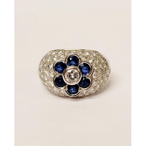 82 - A PRETTY 18CT WHITE GOLD SAPPHIRE & DIAMOND FLORAL CLUSTER / DRESS BOMBE SHAPED RING, the curved set... 