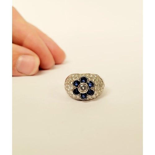 82 - A PRETTY 18CT WHITE GOLD SAPPHIRE & DIAMOND FLORAL CLUSTER / DRESS BOMBE SHAPED RING, the curved set... 