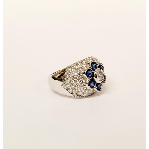 82 - A PRETTY 18CT WHITE GOLD SAPPHIRE & DIAMOND FLORAL CLUSTER / DRESS BOMBE SHAPED RING, the curved set... 