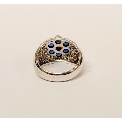 82 - A PRETTY 18CT WHITE GOLD SAPPHIRE & DIAMOND FLORAL CLUSTER / DRESS BOMBE SHAPED RING, the curved set... 