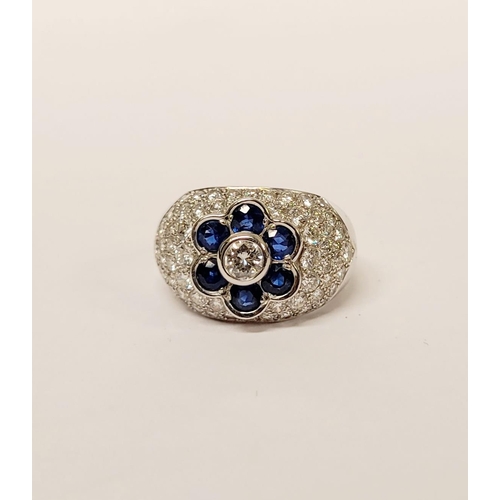 82 - A PRETTY 18CT WHITE GOLD SAPPHIRE & DIAMOND FLORAL CLUSTER / DRESS BOMBE SHAPED RING, the curved set... 
