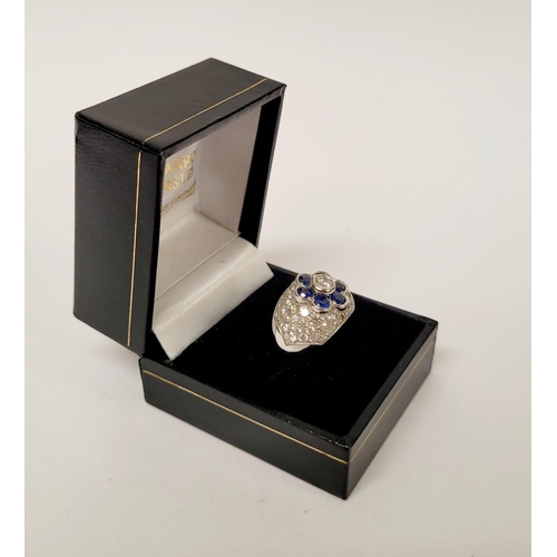 82 - A PRETTY 18CT WHITE GOLD SAPPHIRE & DIAMOND FLORAL CLUSTER / DRESS BOMBE SHAPED RING, the curved set... 
