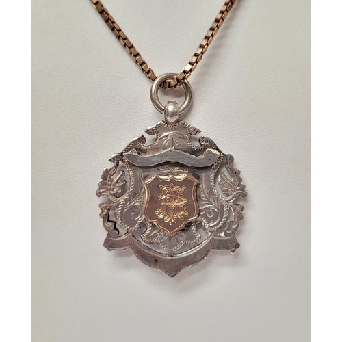 88 - AN EARLY 20TH CENTURY SILVER MEDAL ON AN ITALIAN SILVER CHAIN, the medal with an engraved open work ... 