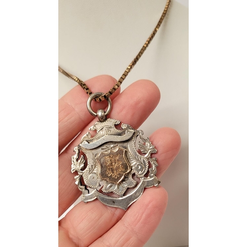 88 - AN EARLY 20TH CENTURY SILVER MEDAL ON AN ITALIAN SILVER CHAIN, the medal with an engraved open work ... 