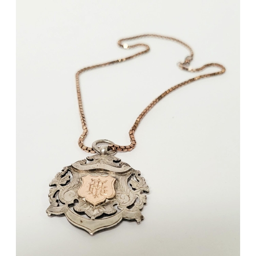 88 - AN EARLY 20TH CENTURY SILVER MEDAL ON AN ITALIAN SILVER CHAIN, the medal with an engraved open work ... 