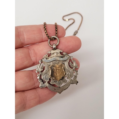88 - AN EARLY 20TH CENTURY SILVER MEDAL ON AN ITALIAN SILVER CHAIN, the medal with an engraved open work ... 