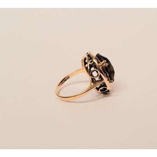104 - A VERY FINE 9CT YELLOW GOLD SMOKY QUARTZ DRESS RING, the large oval shaped smoky quartz stone is set... 