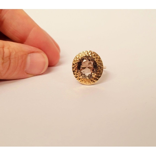 104 - A VERY FINE 9CT YELLOW GOLD SMOKY QUARTZ DRESS RING, the large oval shaped smoky quartz stone is set... 