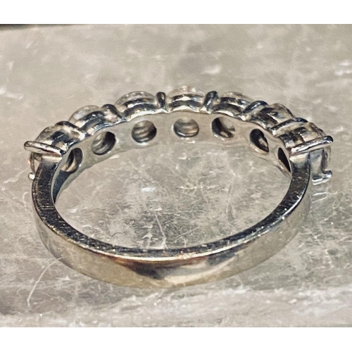 107 - AN 18CT WHITE GOLD 7 STONE DIAMOND RING, the diamonds in a claw setting. Total weight 2.20cts, with ... 