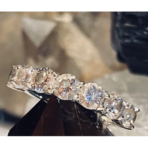 107 - AN 18CT WHITE GOLD 7 STONE DIAMOND RING, the diamonds in a claw setting. Total weight 2.20cts, with ... 