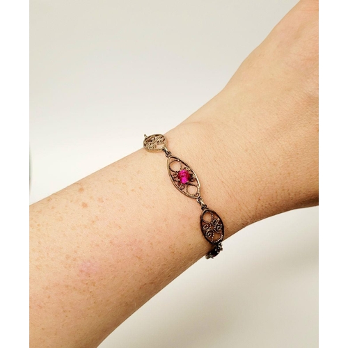 114 - A VINTAGE STERLING SILVER FILGREE WORK BRACELET WITH PINK GEMSTONE SETTING, a lovely piece of jewell... 