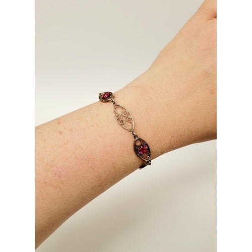 114 - A VINTAGE STERLING SILVER FILGREE WORK BRACELET WITH PINK GEMSTONE SETTING, a lovely piece of jewell... 