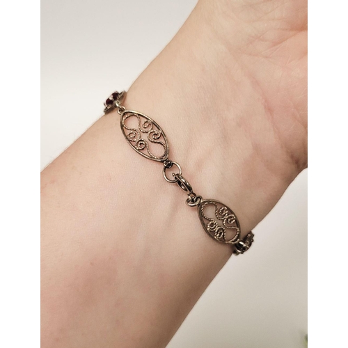 114 - A VINTAGE STERLING SILVER FILGREE WORK BRACELET WITH PINK GEMSTONE SETTING, a lovely piece of jewell... 
