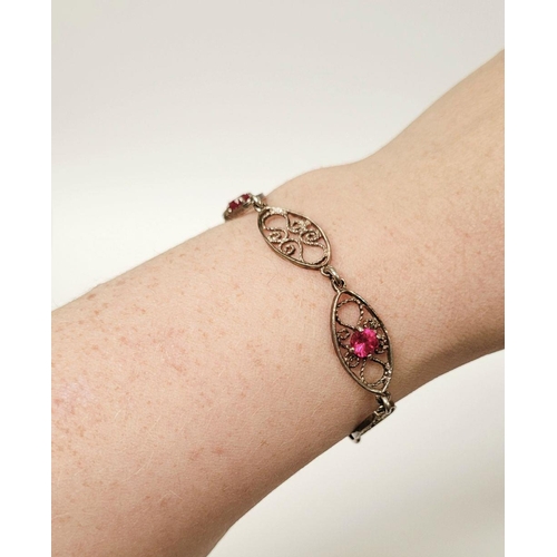 114 - A VINTAGE STERLING SILVER FILGREE WORK BRACELET WITH PINK GEMSTONE SETTING, a lovely piece of jewell... 