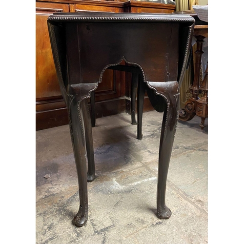 184 - AN 18TH CENTURY MAHOGANY DROP LEAF DINING TABLE, circular top with carved beaded border raised on le... 