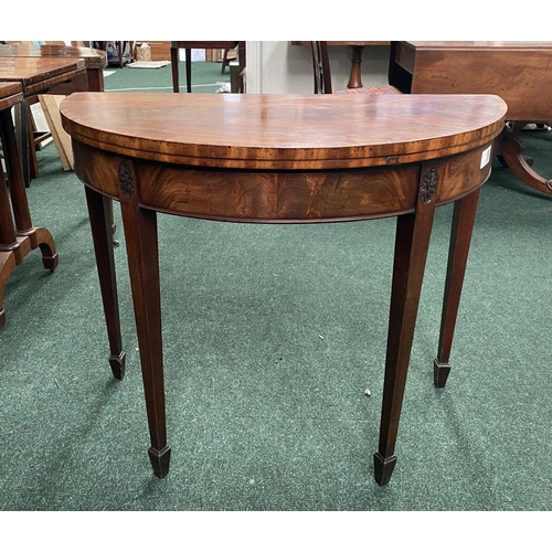 214 - A BRIGHT DEMI LUNE GEORGIAN FLAME MAHOGANY FOLD OVER CARD TABLE, presenting a beautiful finish with ... 