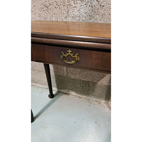 216 - A GOOD GEORGE III FOLD OVER MAHOGANY TEA TABLE with a break front design to the fold over top, venee... 