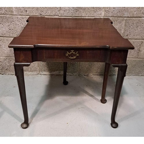 216 - A GOOD GEORGE III FOLD OVER MAHOGANY TEA TABLE with a break front design to the fold over top, venee... 