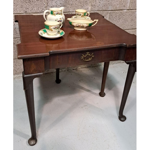 216 - A GOOD GEORGE III FOLD OVER MAHOGANY TEA TABLE with a break front design to the fold over top, venee... 