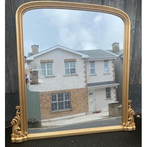221 - A GILT ARCHED OVERMANTLE MIRROR, with fluting to frame and scroll design to base. Dimensions: 4ft 6i... 