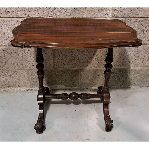 225 - A SERPENTINE SHAPED SIDE / LAMP TABLE RAISED ON A FINELY CARVED POD SUPPORT, a pair of columns sit u... 