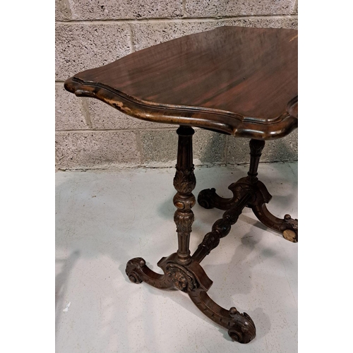 225 - A SERPENTINE SHAPED SIDE / LAMP TABLE RAISED ON A FINELY CARVED POD SUPPORT, a pair of columns sit u... 