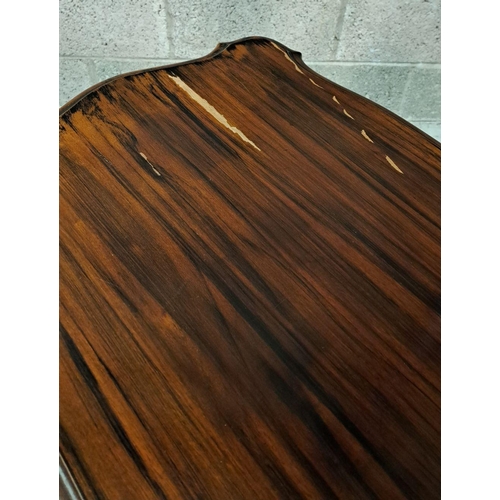 225 - A SERPENTINE SHAPED SIDE / LAMP TABLE RAISED ON A FINELY CARVED POD SUPPORT, a pair of columns sit u... 