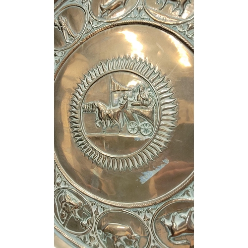 229 - TWO POLISHED BRASS DECORATIVE TRAYS, (i) One a brass zodiac charger/tray; decorated with figures in ... 