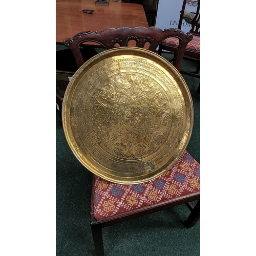 229 - TWO POLISHED BRASS DECORATIVE TRAYS, (i) One a brass zodiac charger/tray; decorated with figures in ... 