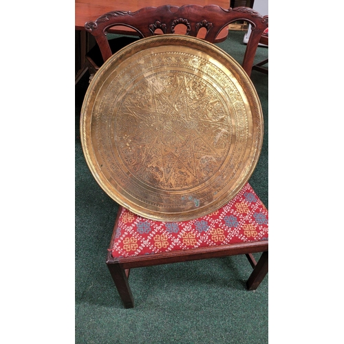 229 - TWO POLISHED BRASS DECORATIVE TRAYS, (i) One a brass zodiac charger/tray; decorated with figures in ... 