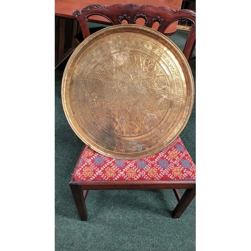 229 - TWO POLISHED BRASS DECORATIVE TRAYS, (i) One a brass zodiac charger/tray; decorated with figures in ... 