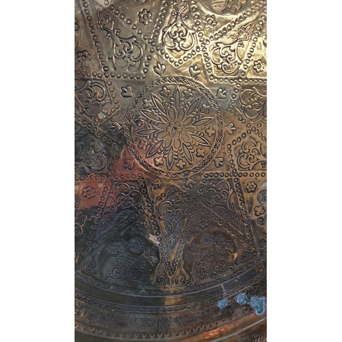 229 - TWO POLISHED BRASS DECORATIVE TRAYS, (i) One a brass zodiac charger/tray; decorated with figures in ... 