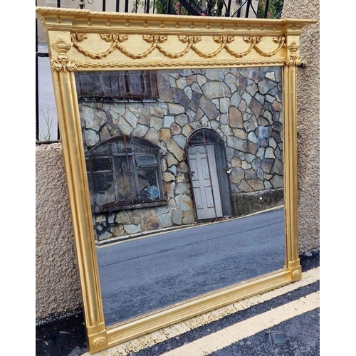 231 - A FINE GILT OVERMANTLE MIRROR, pier form, with cornice above bow and swag design in relief, pier sup... 