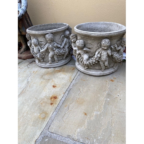239 - A LOVELY PAIR OF CIRCULAR GARDEN PLANTER POTS, decorated all around with raised relief design in the... 