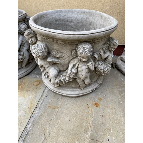 239 - A LOVELY PAIR OF CIRCULAR GARDEN PLANTER POTS, decorated all around with raised relief design in the... 