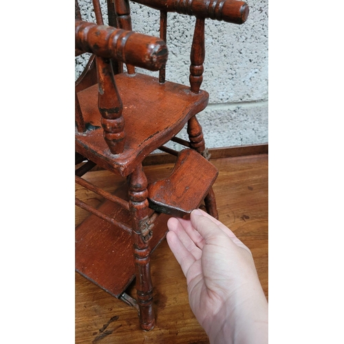 65 - AN ANTIQUE METAMORPHIC DOLLS HIGH CHAIR, with tray & foot rests, turned supports & arm rests. Folds ... 