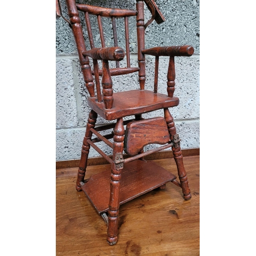 65 - AN ANTIQUE METAMORPHIC DOLLS HIGH CHAIR, with tray & foot rests, turned supports & arm rests. Folds ... 
