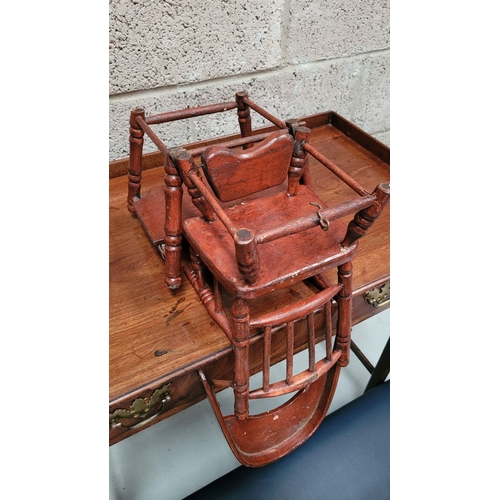 65 - AN ANTIQUE METAMORPHIC DOLLS HIGH CHAIR, with tray & foot rests, turned supports & arm rests. Folds ... 