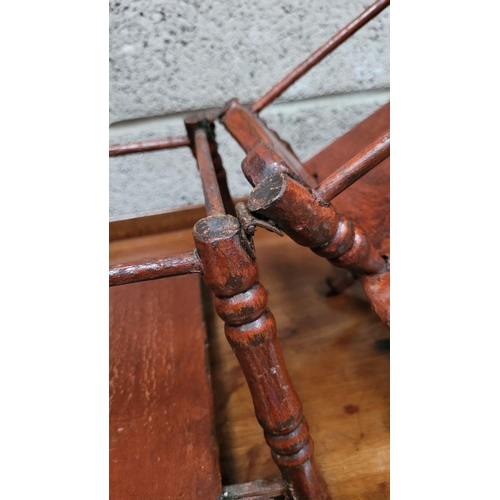 65 - AN ANTIQUE METAMORPHIC DOLLS HIGH CHAIR, with tray & foot rests, turned supports & arm rests. Folds ... 